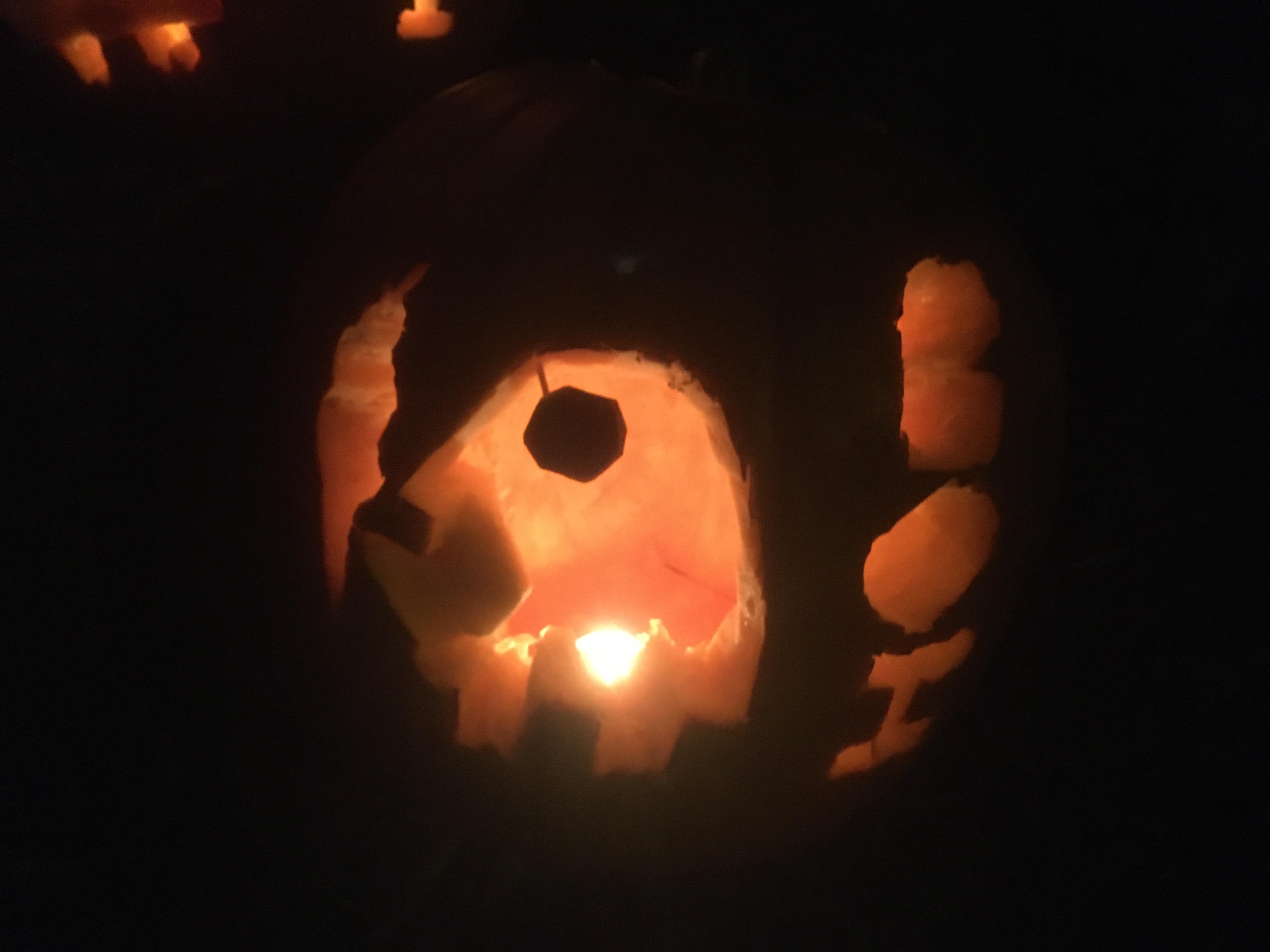 Carved into the pumpkin is an penguin holding an ice-cream cone, next to the word BOI.